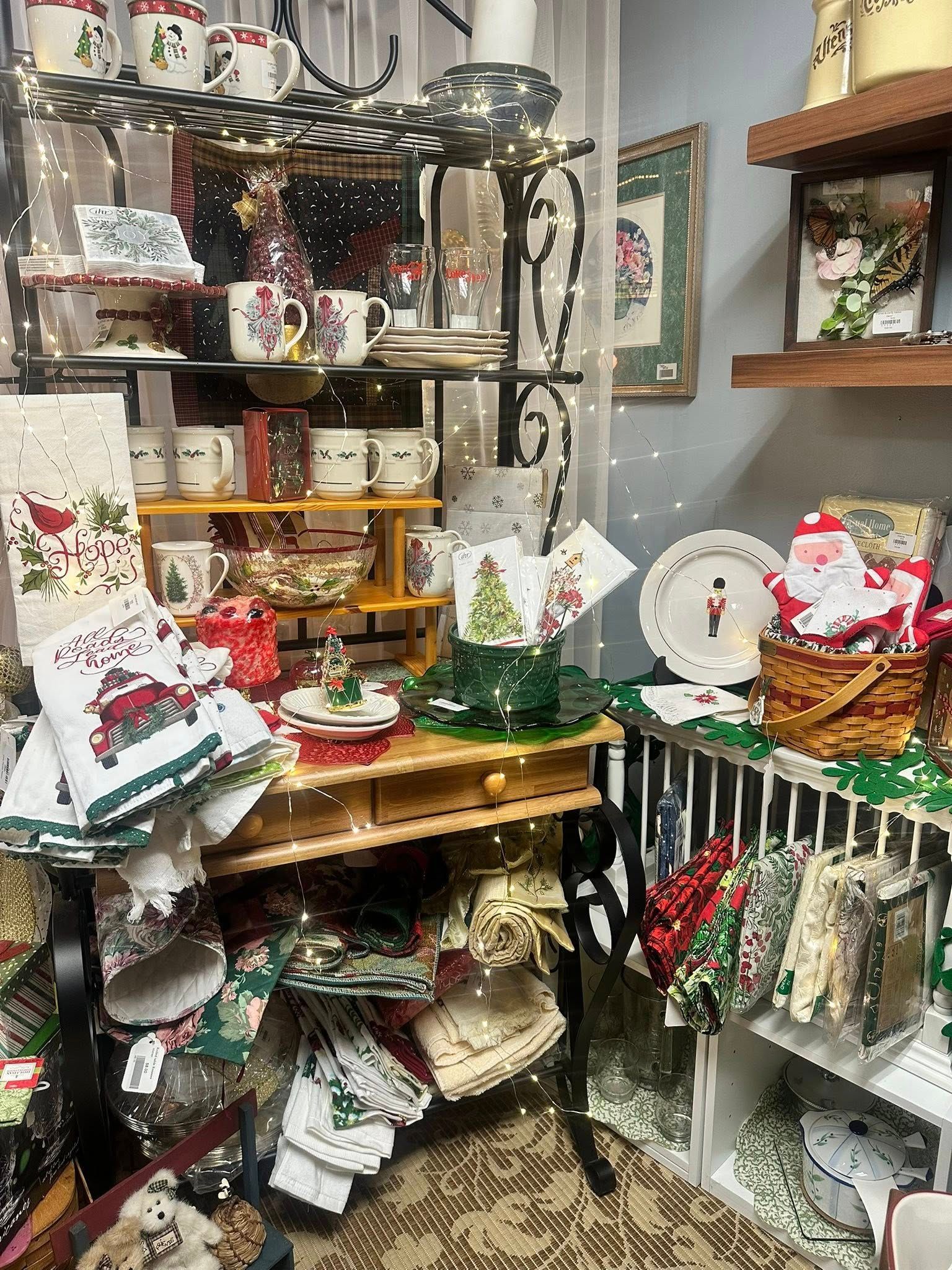 Christmas themed items displayed on shelves and tables in a store.