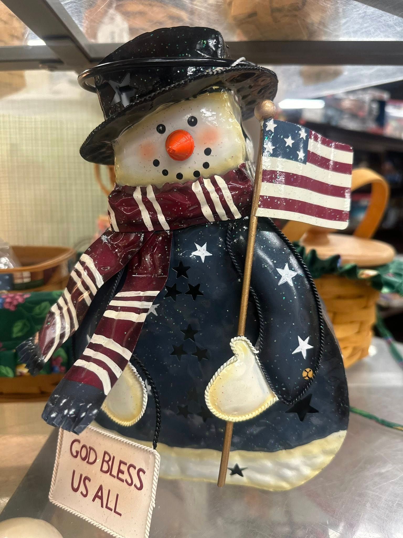 Snowman decoration with black hat, waving American flag, and 