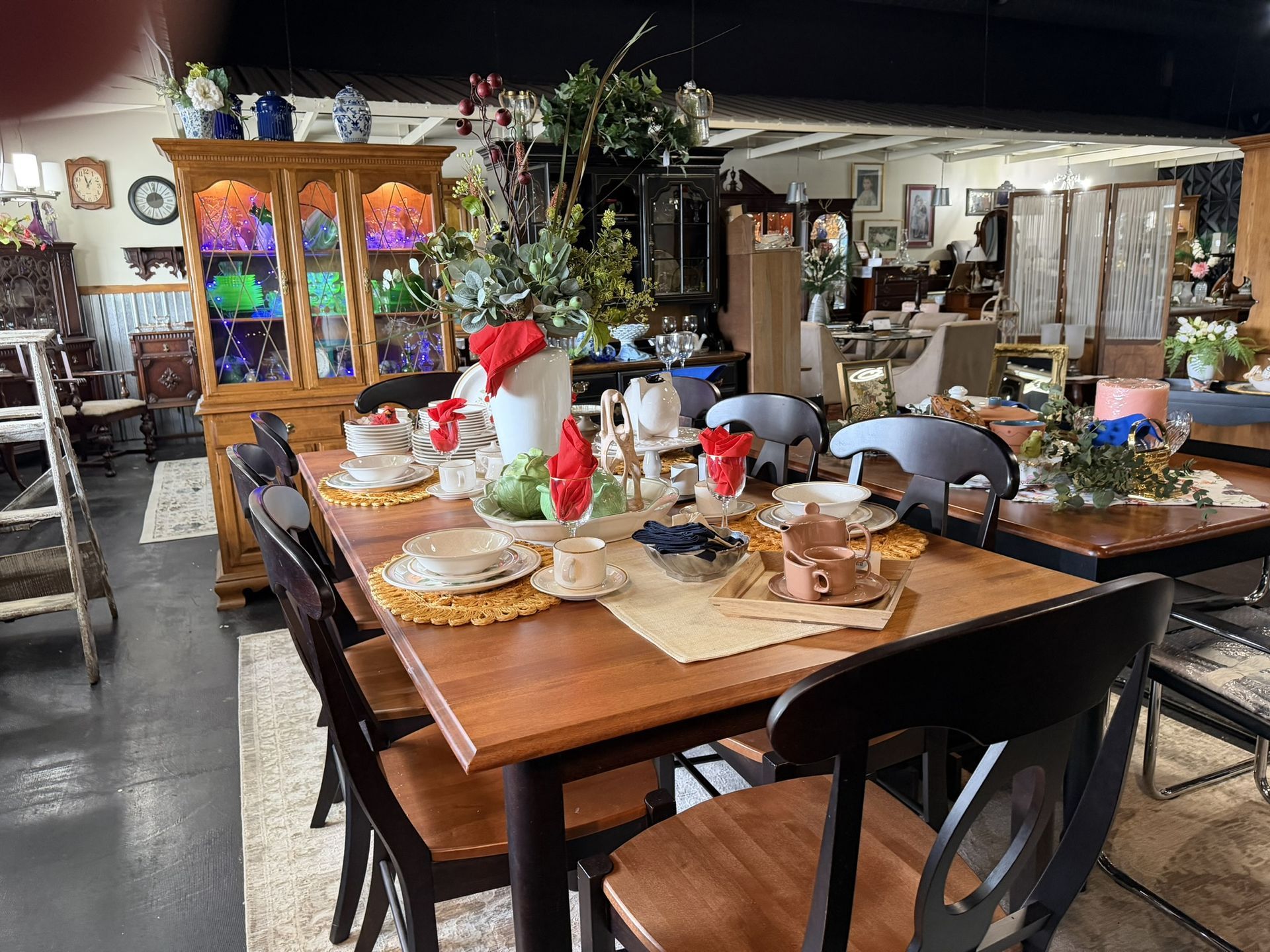 Set dining table in a rustic restaurant with plates, glasses, and flower centerpiece