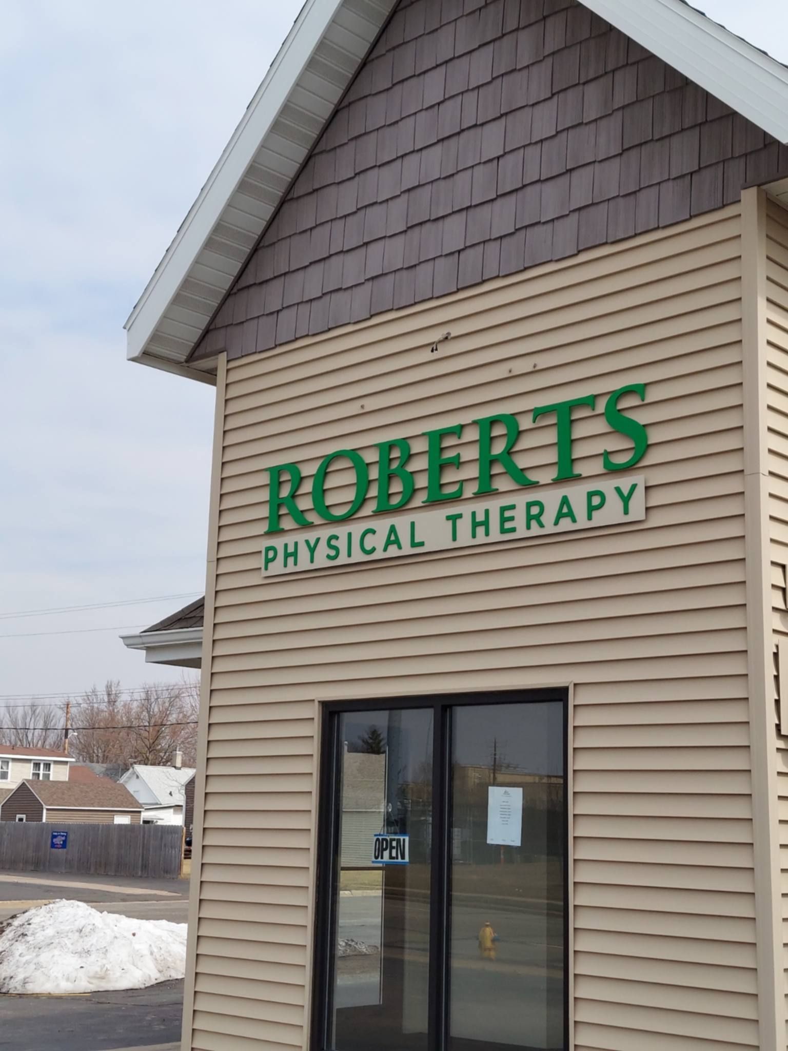 A tan building with a sign that reads