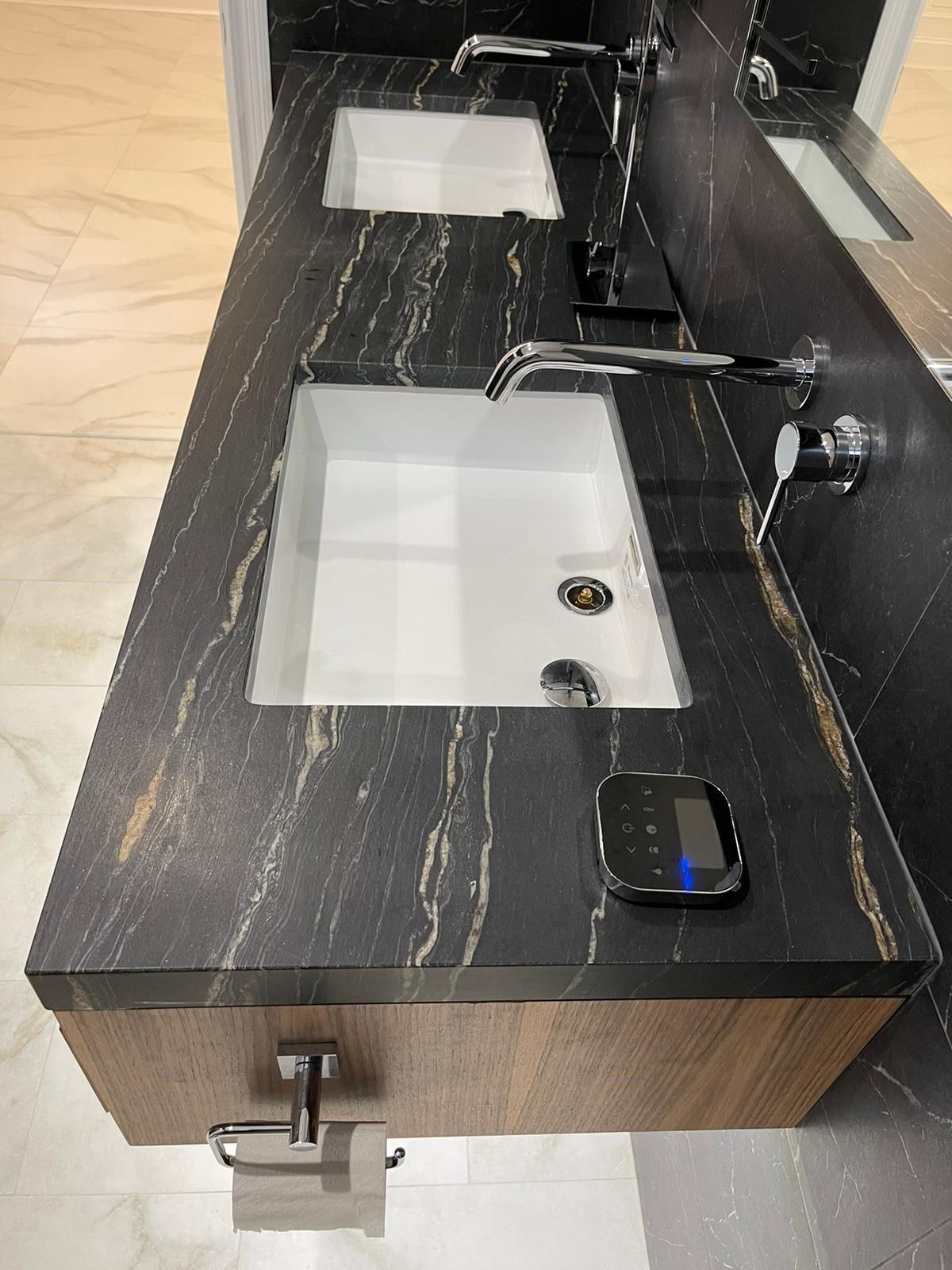 a bathroom with two sinks and a mirror