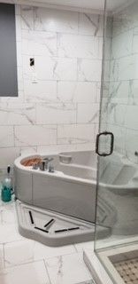 A bathroom with a bathtub and a walk-in shower