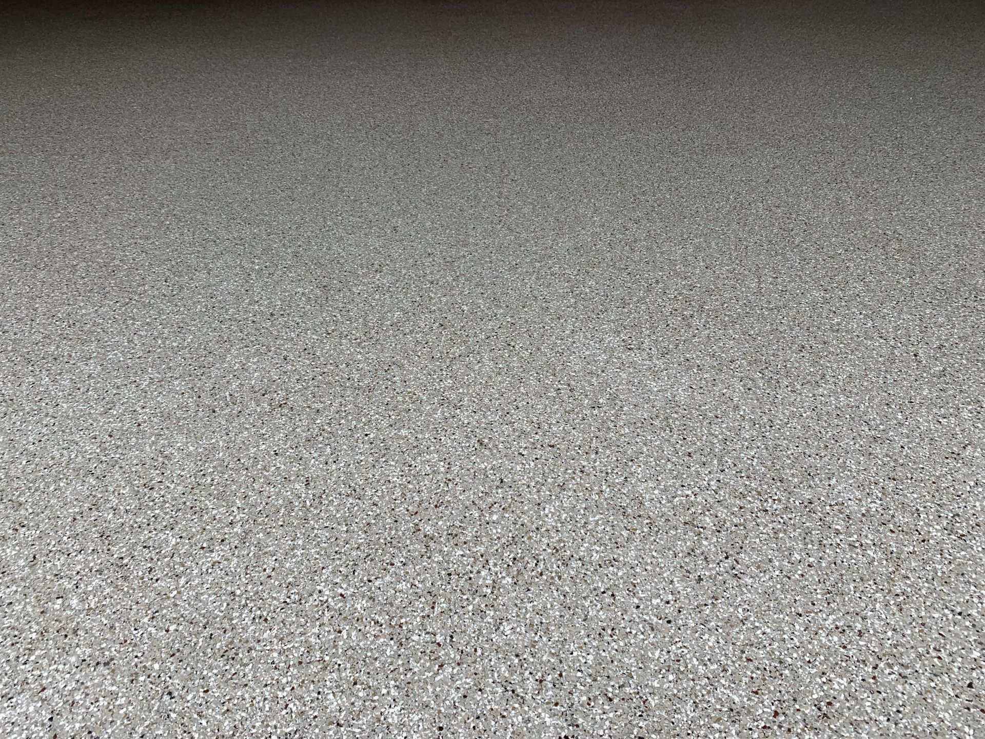 Close-up of a gray, speckled textured surface filling the frame.