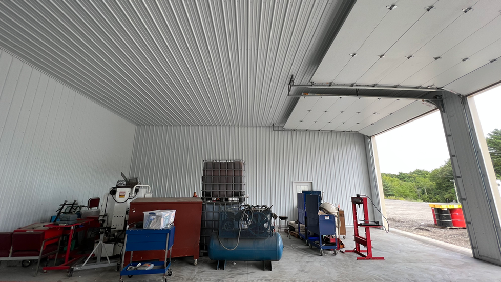 A garage with a lot of tools and equipment in it.