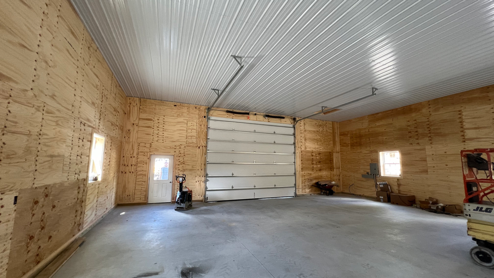 A large empty garage with a large garage door.