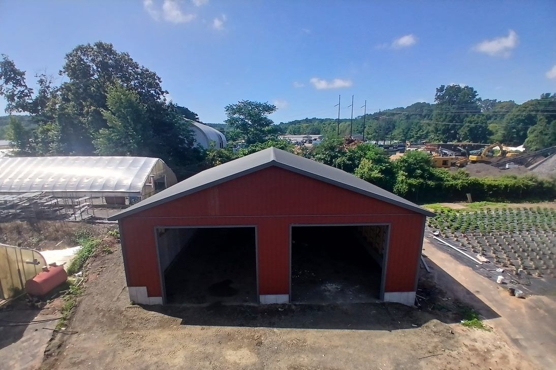 An aerial view of a red barn with two doors