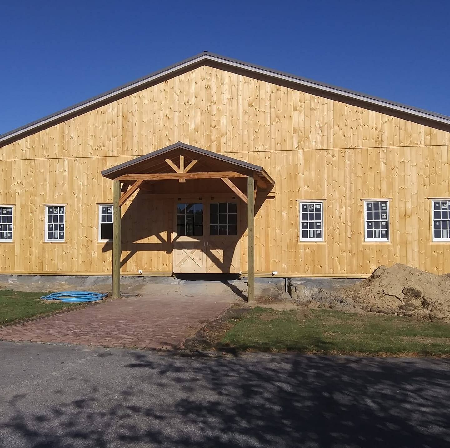 A large wooden building with a porch and windows