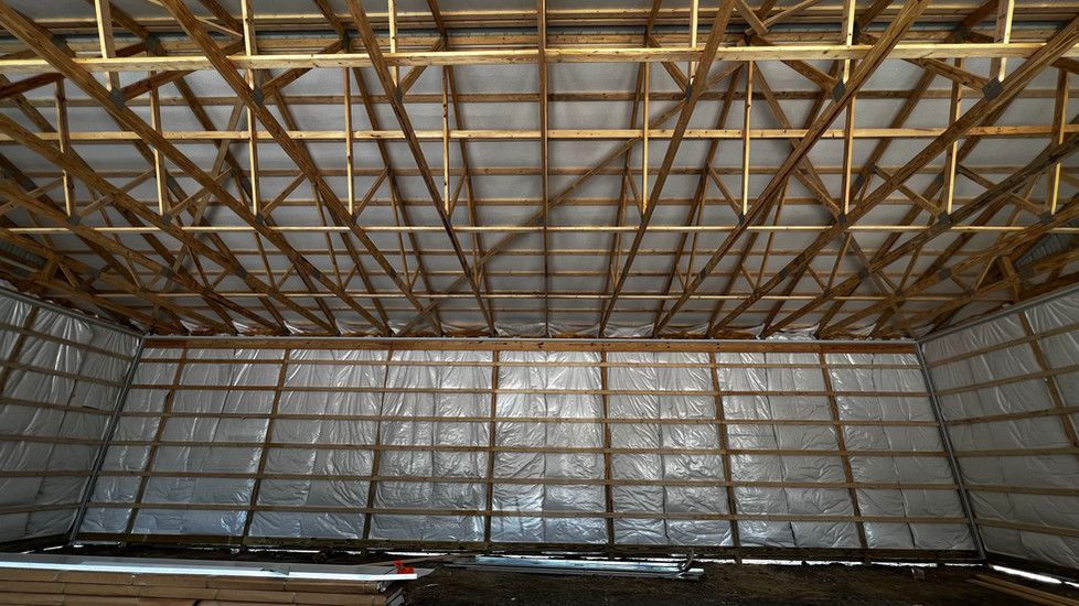 The inside of a building under construction with a lot of wooden beams.