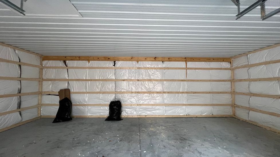 An empty garage with a lot of insulation on the walls and ceiling.