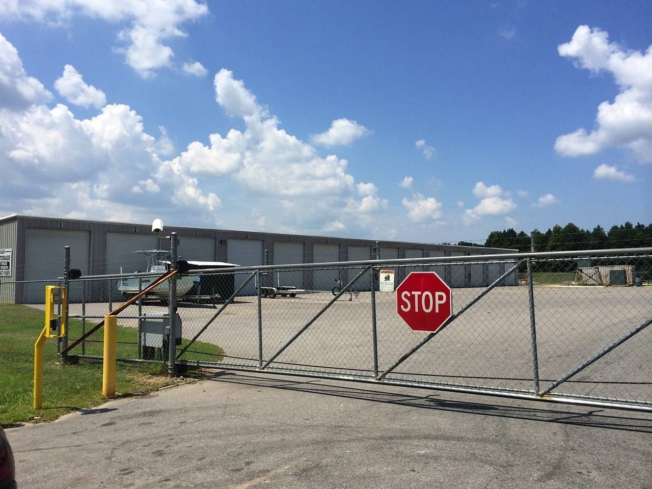 A stop sign is on a gate in front of a building