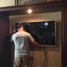 man installing a tv