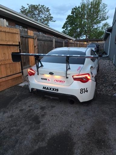 White sports car with large spoiler,