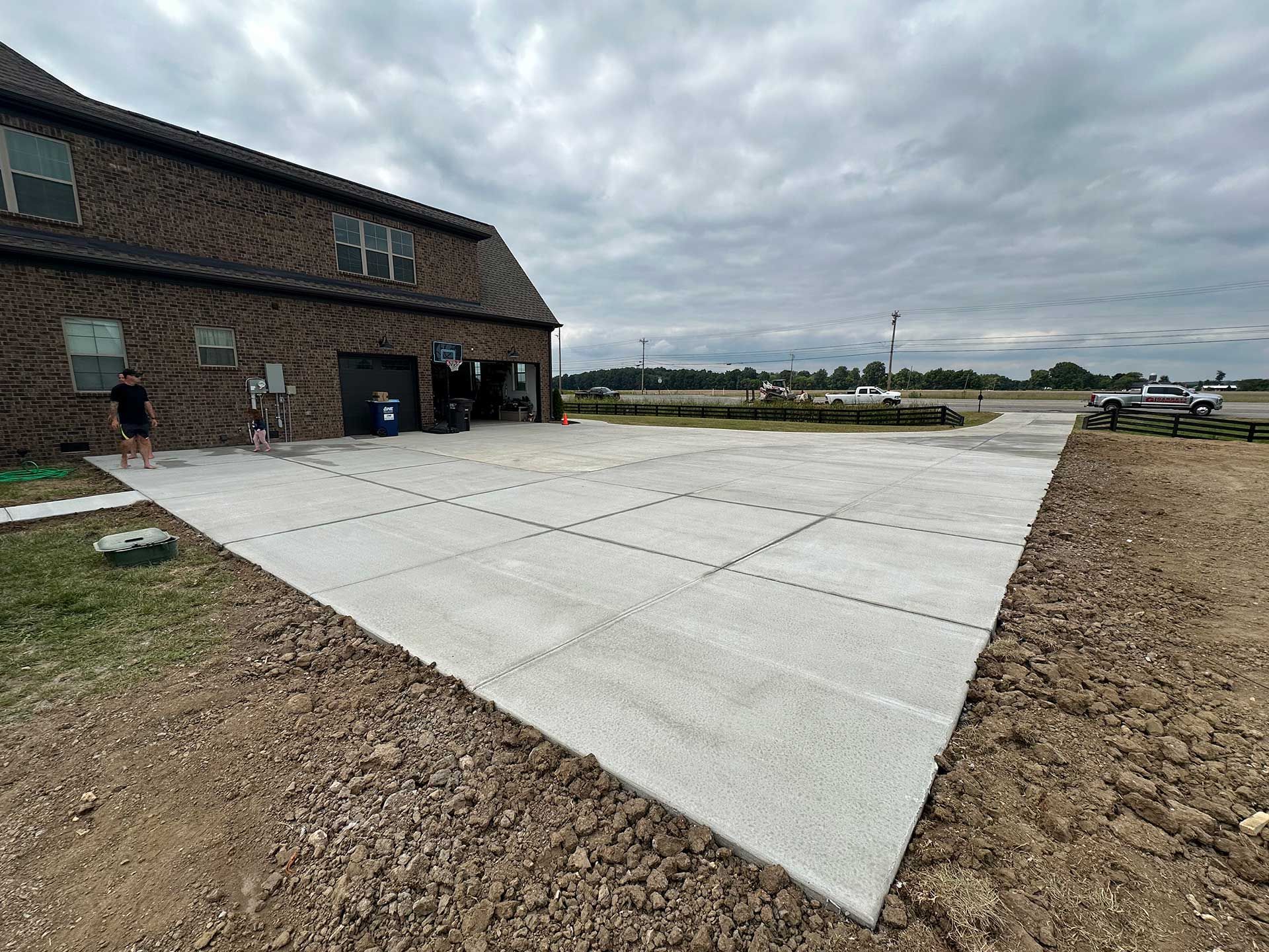 exterior view of a brick building with a newly poured concrete driveway