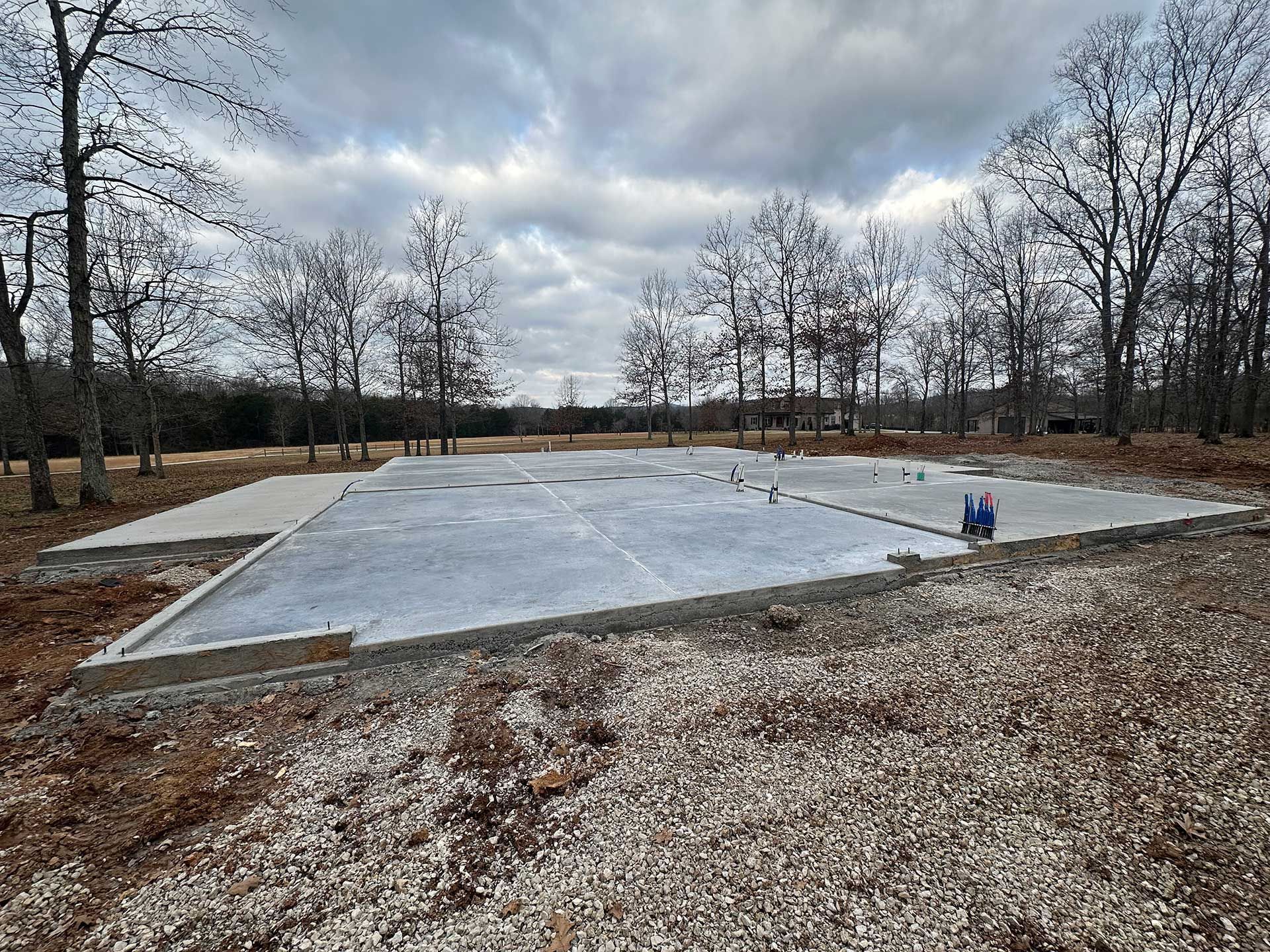 concrete foundation slab in a wooded area