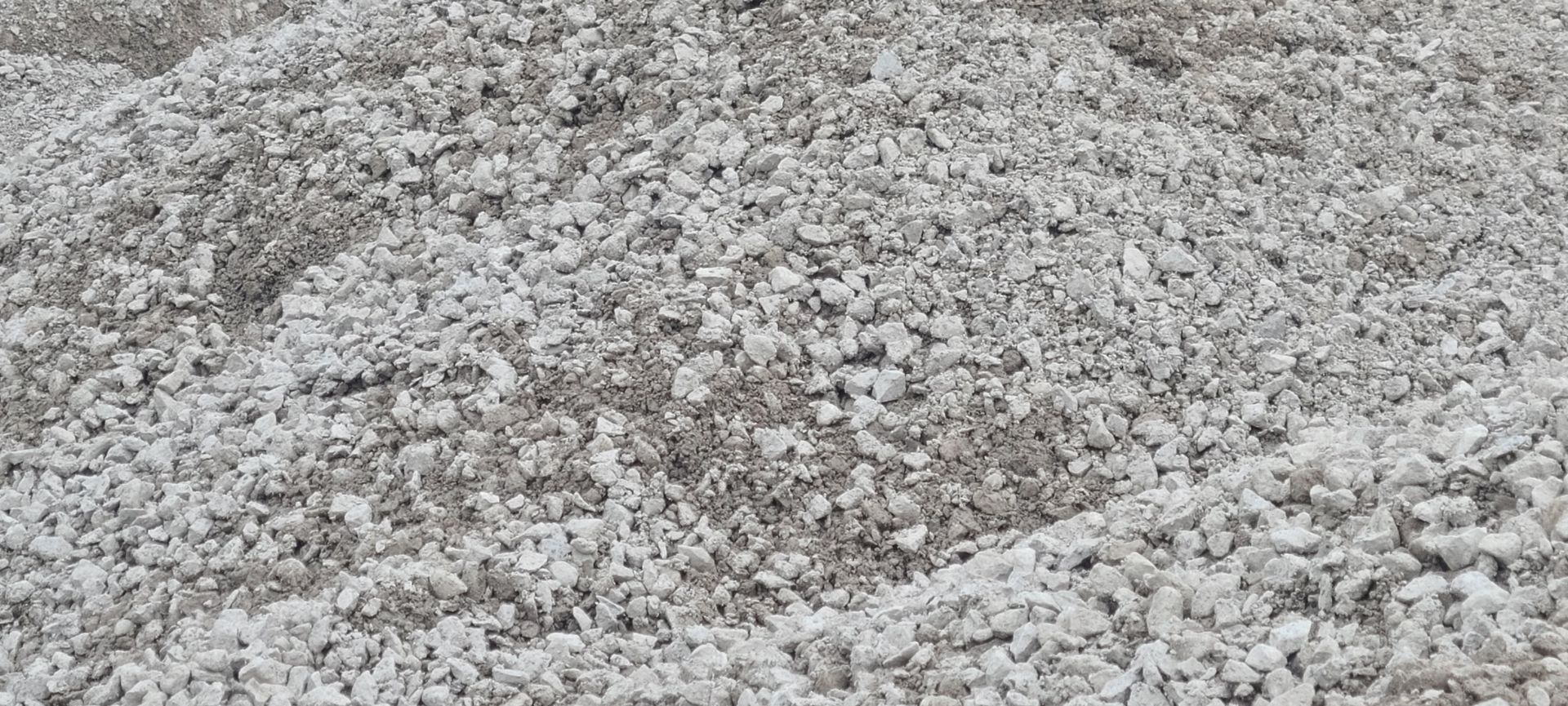 Pile of gray gravel or crushed stone filling the frame
