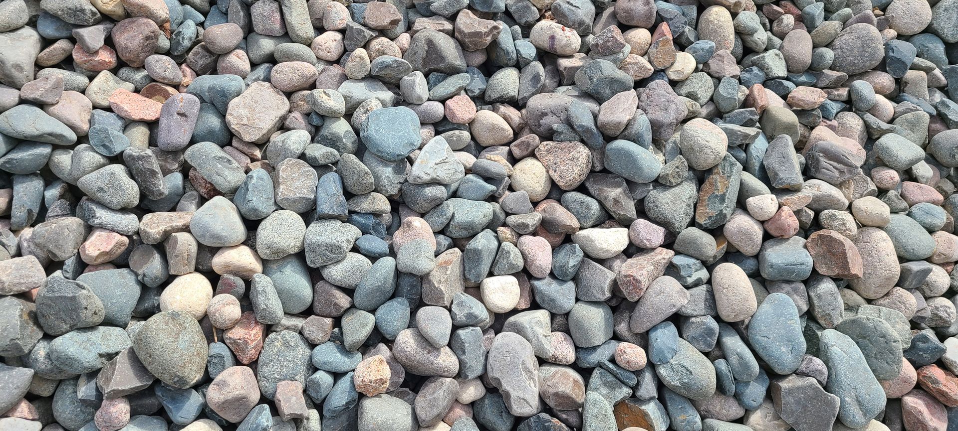 Close-up of small gray and brown pebbles covering the ground