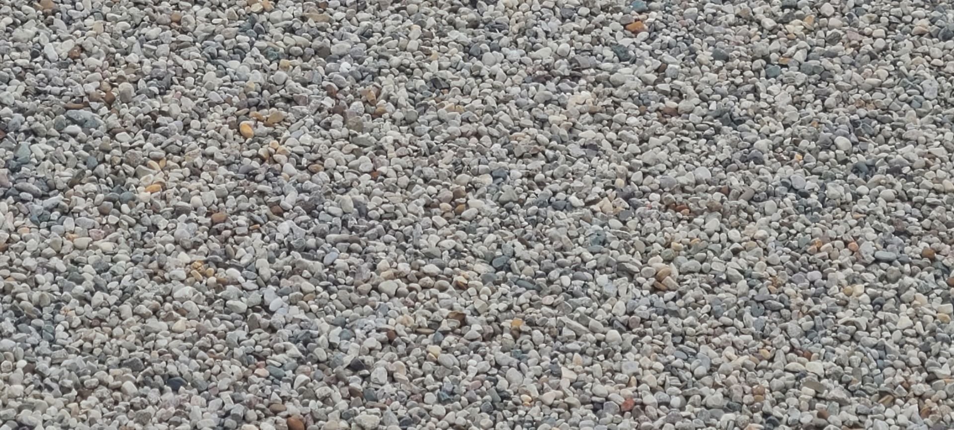 Close-up of small gray and tan gravel stones covering the ground
