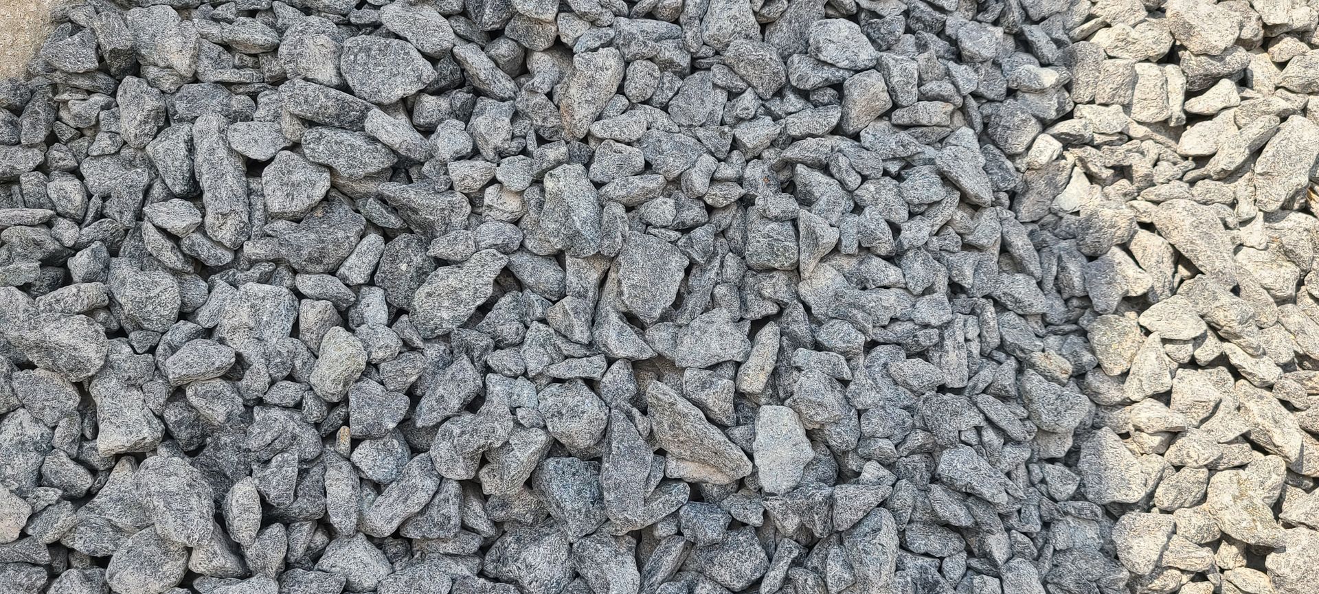 Close-up of gray gravel with a small strip of tan gravel on the right