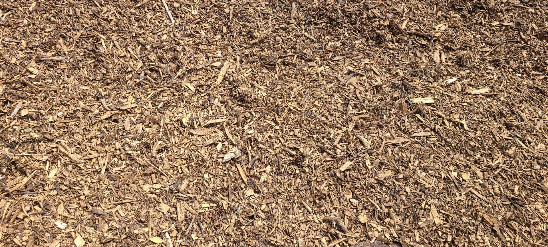 Pile of brown wood chips covering the ground