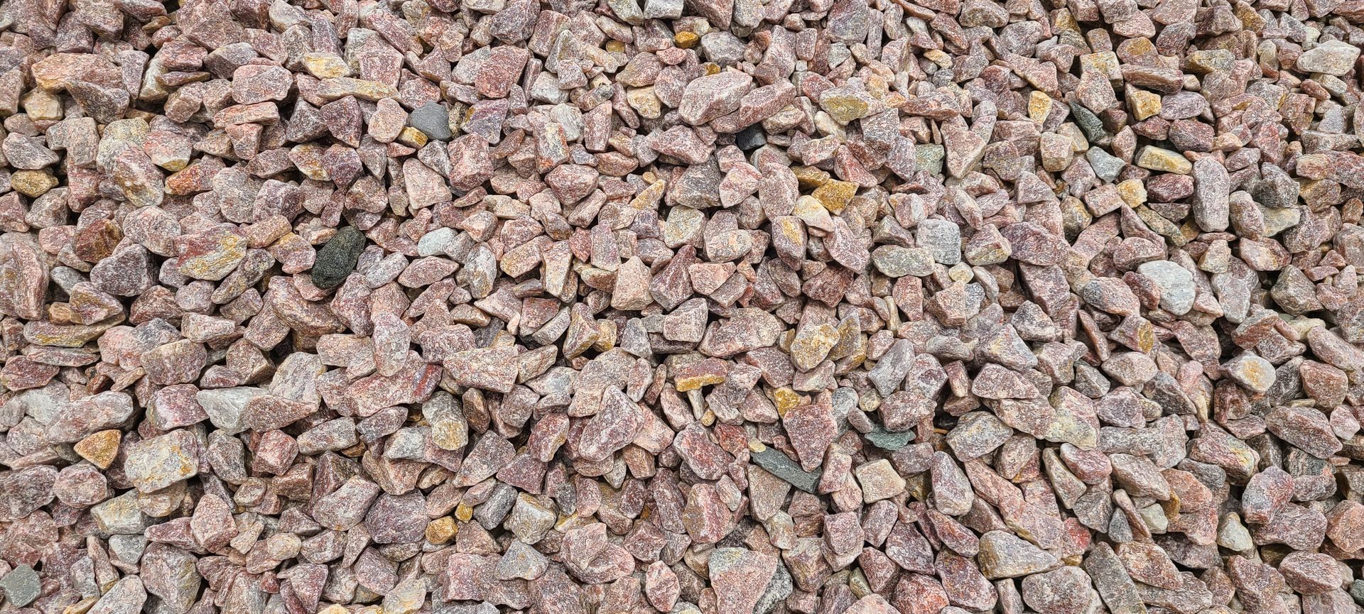 Close-up of small pink and tan gravel stones filling the frame