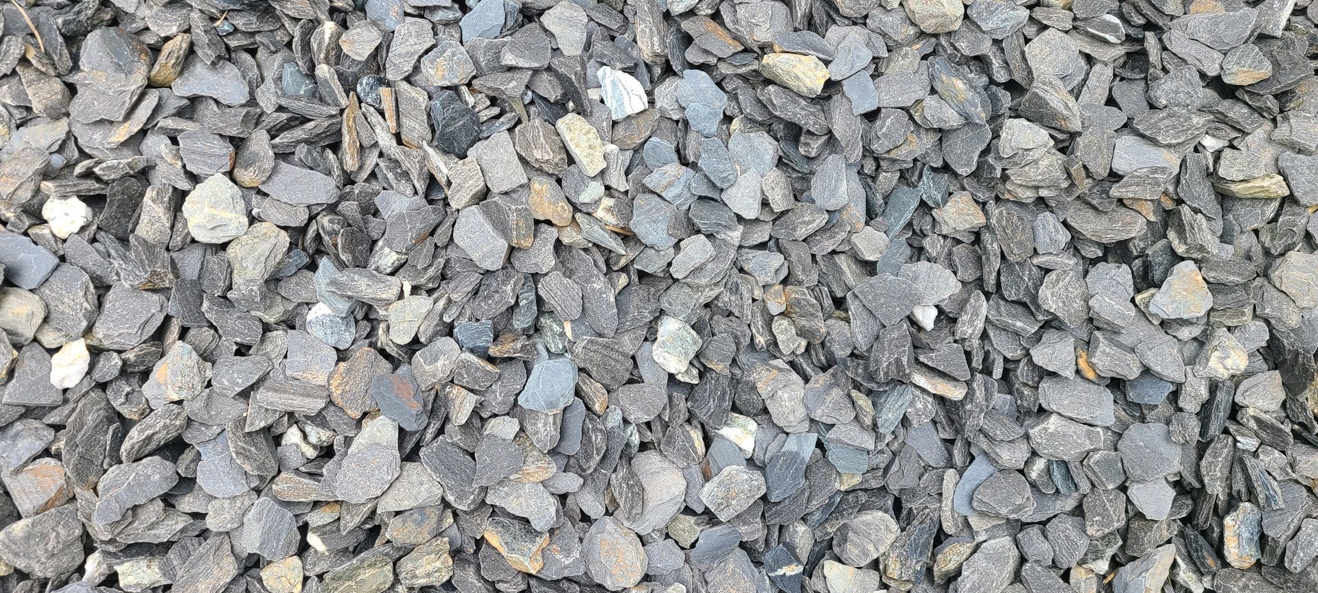 Close-up of gray and tan gravel stones filling the frame