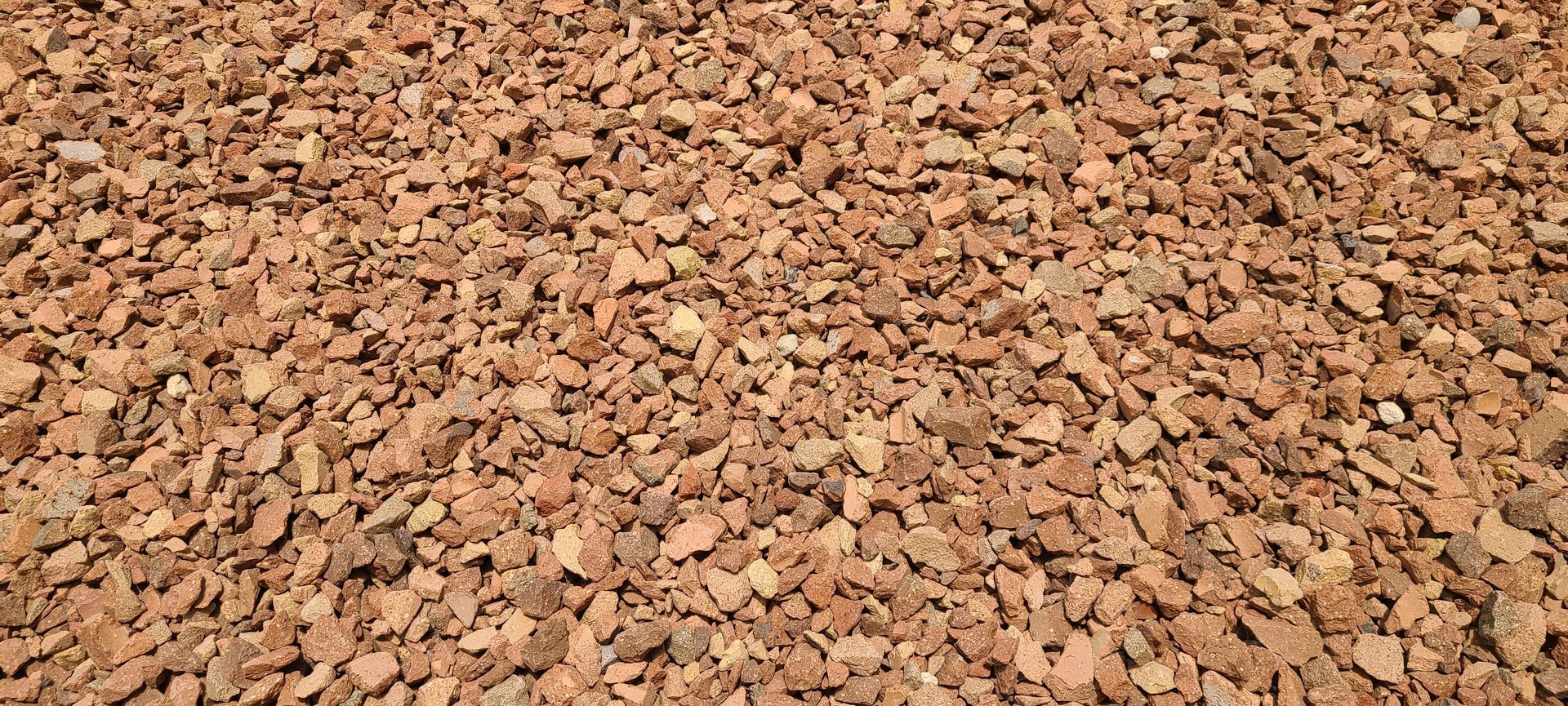 Close-up of reddish-brown gravel or crushed stone filling the frame.