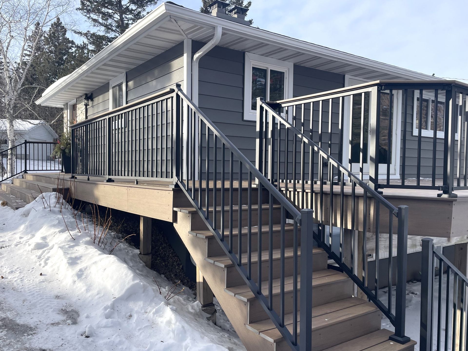 A house with a deck and stairs leading up to it