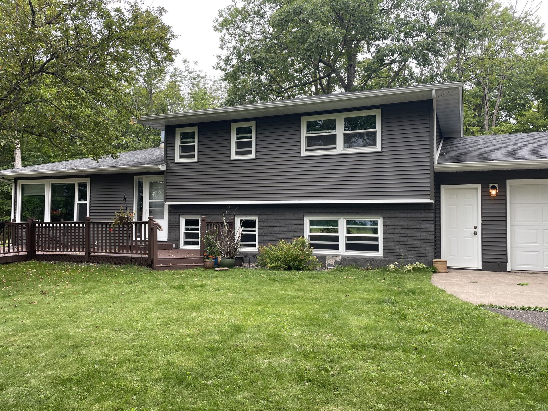 A large house with a lot of windows and a large lawn in front of it.