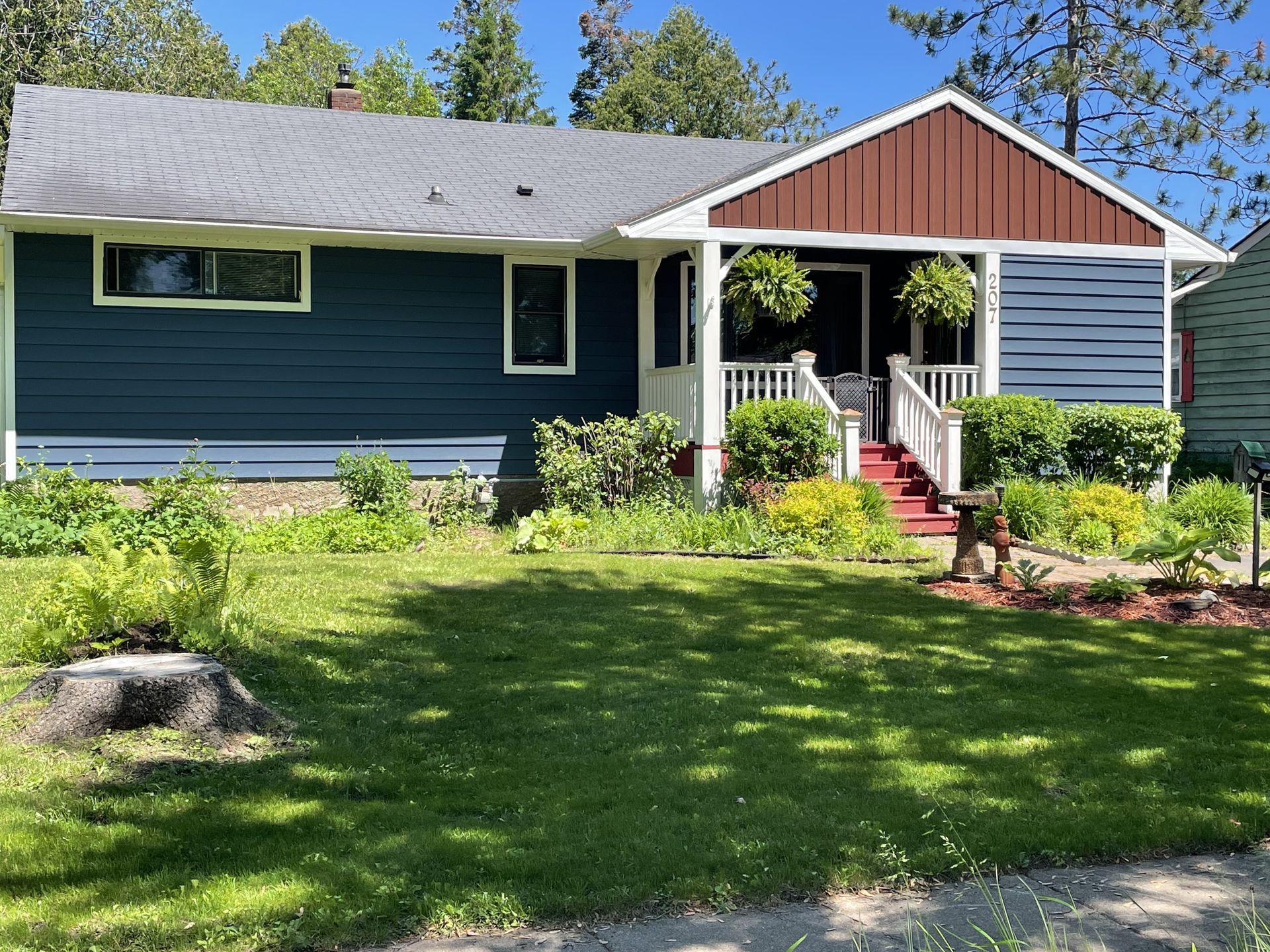 A house with a blue siding and a red roof