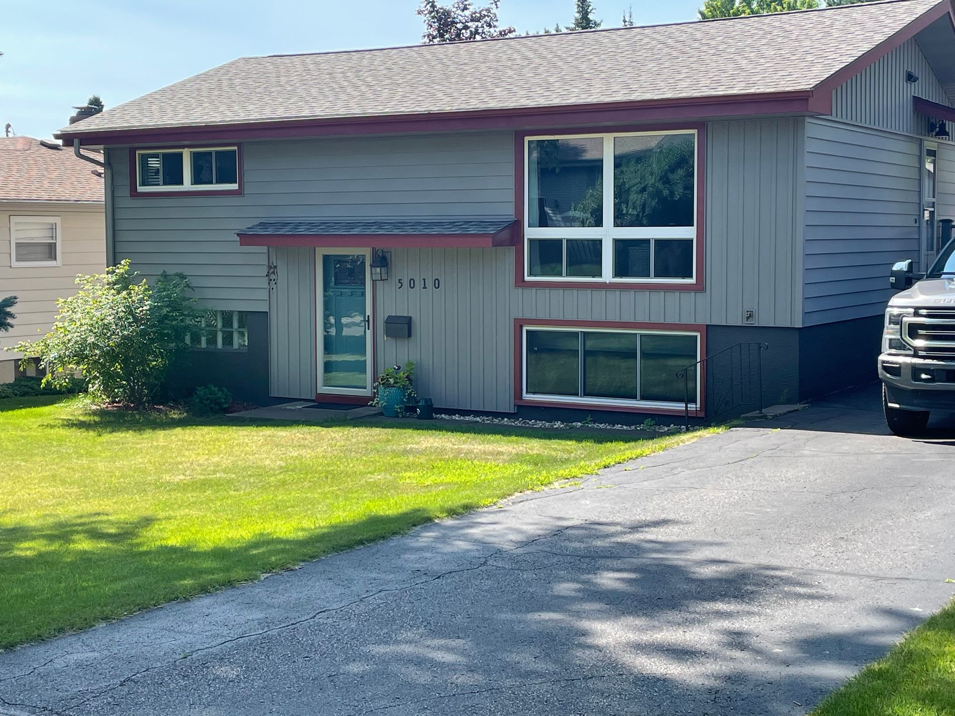 A house with a truck parked in front of it.