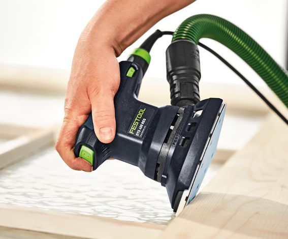 A person is using a Festool sander on a piece of wood