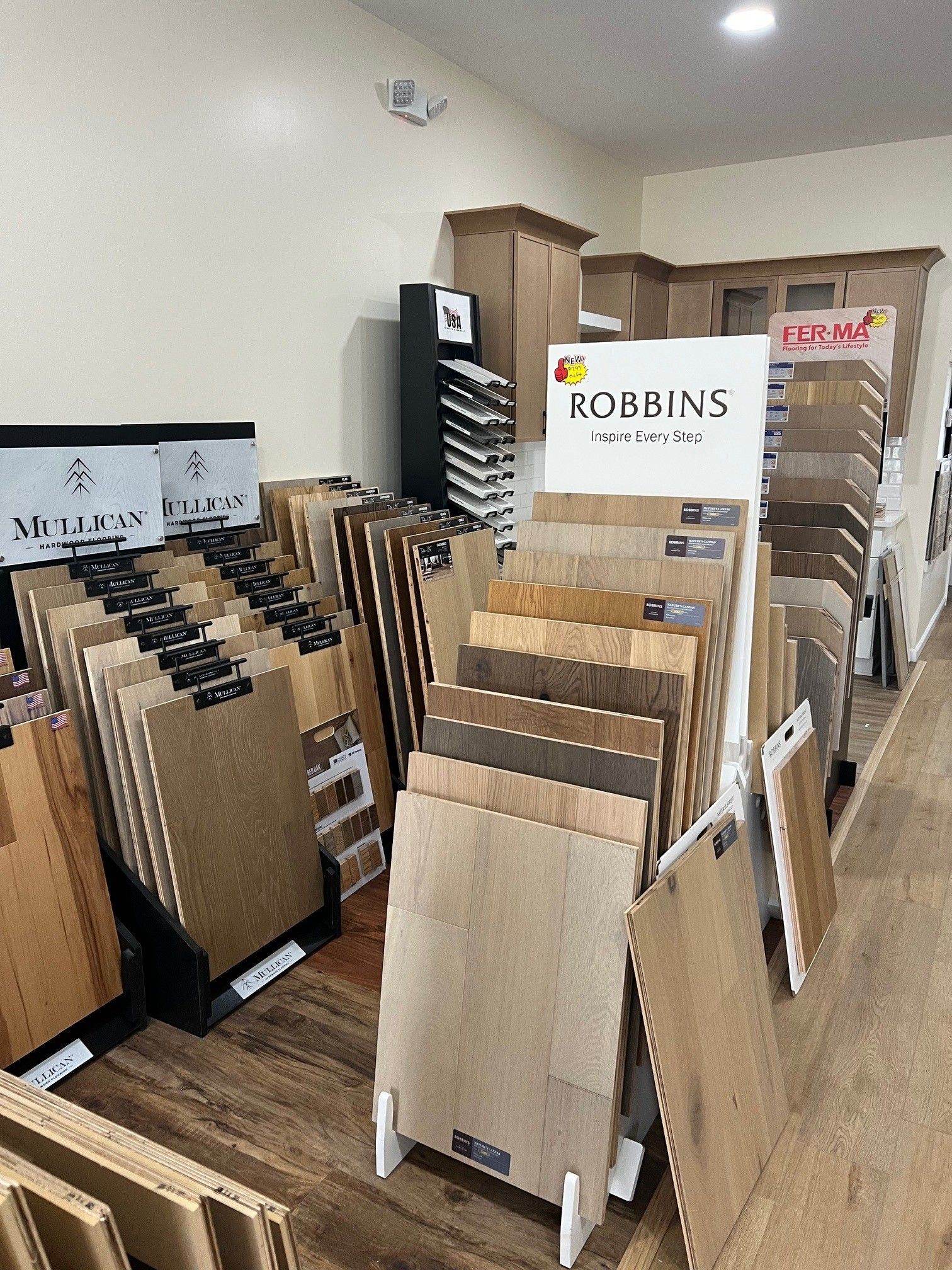 Showroom with rows of wood and laminate flooring samples on display racks