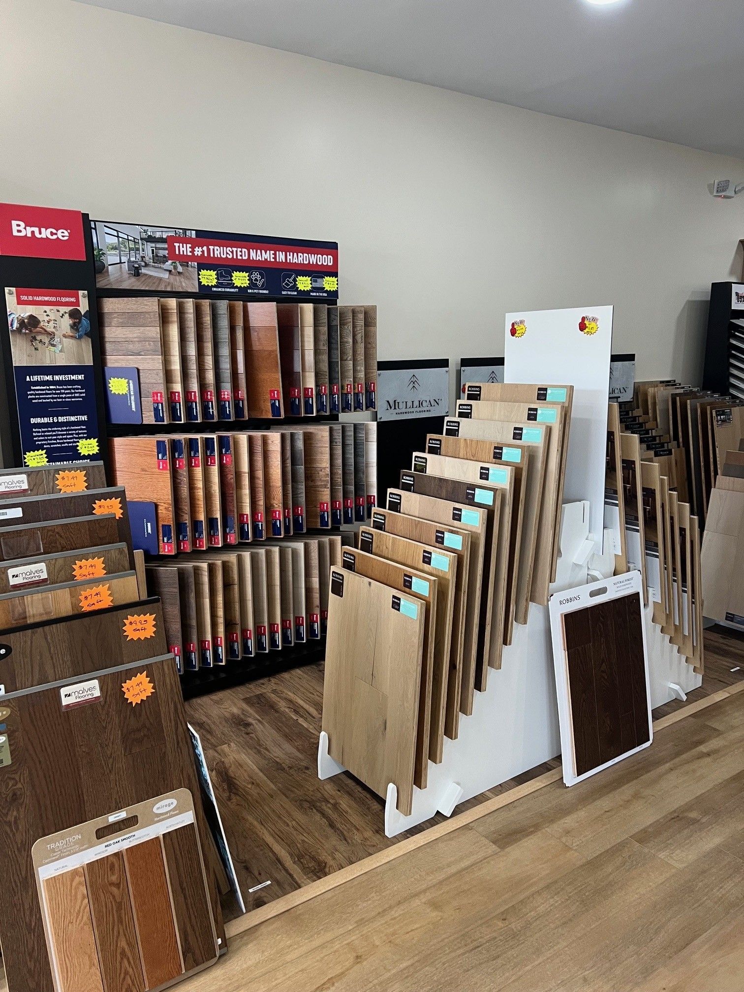 Flooring showroom display with samples and upright panels on a wooden floor