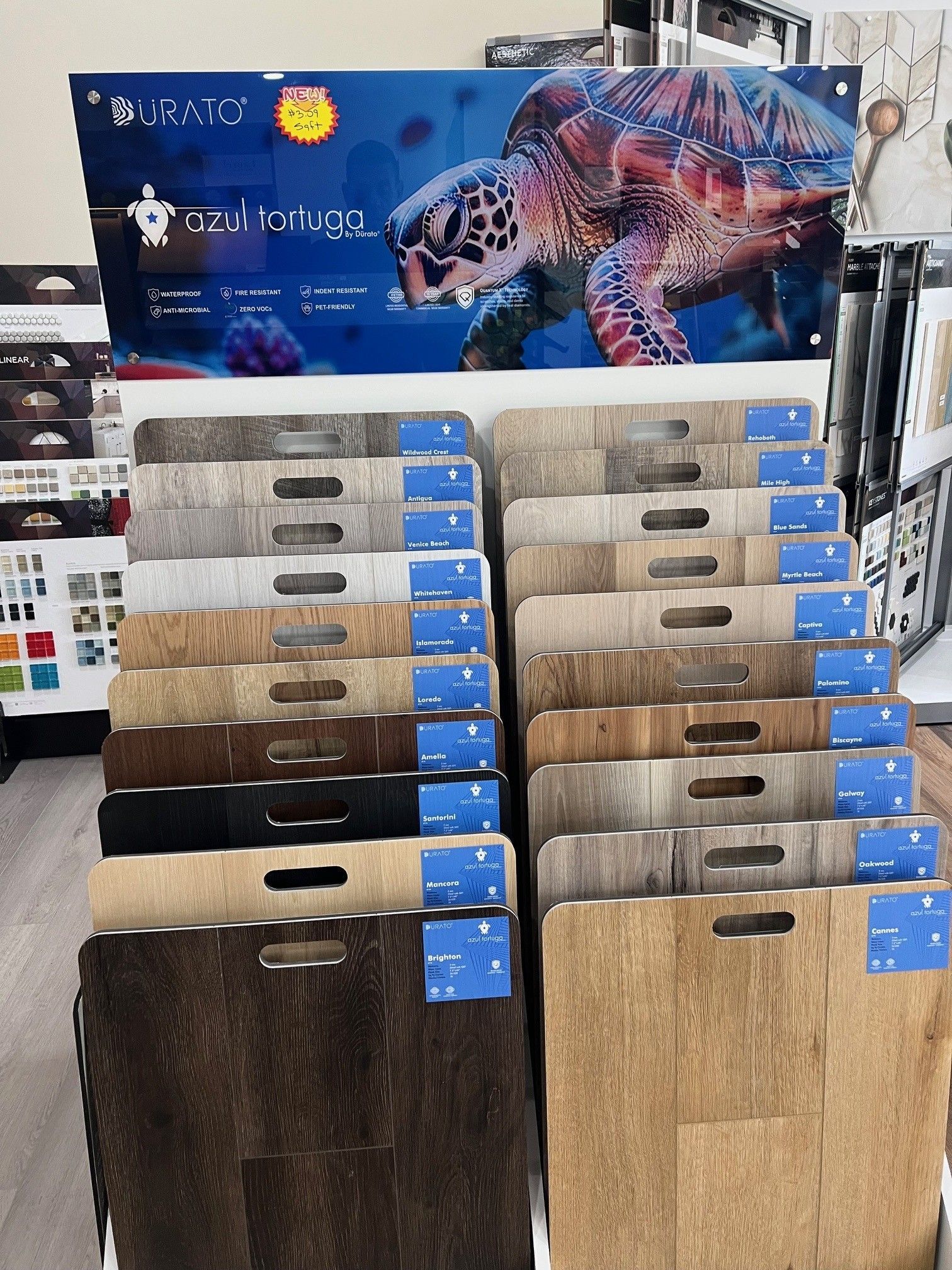 Display of patterned wood sample boards with a colorful sea turtle banner above them
