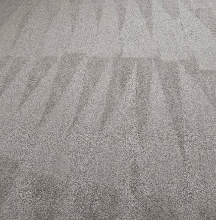 Gray carpet with subtle striped patterns and shadows