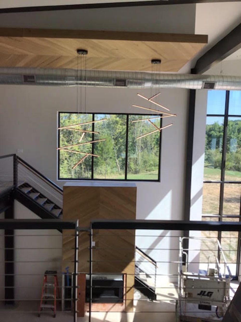 A room with a staircase and a lot of windows