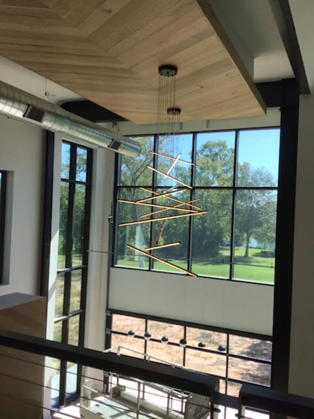 A large room with a lot of windows and a chandelier hanging from the ceiling.