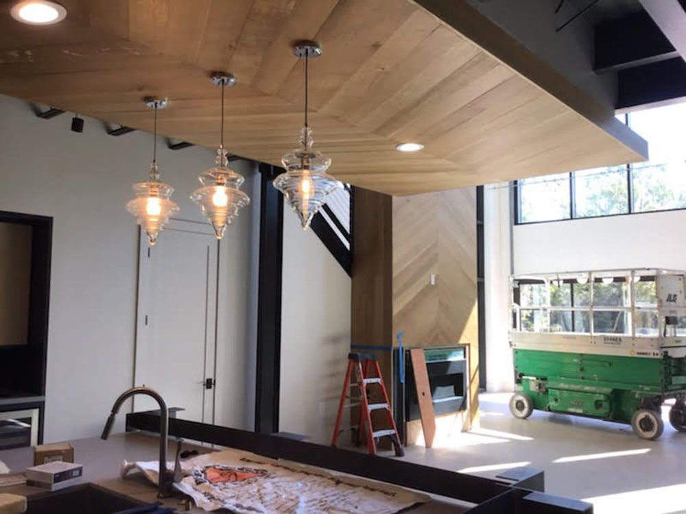 A kitchen with a wooden ceiling with beautiful lights