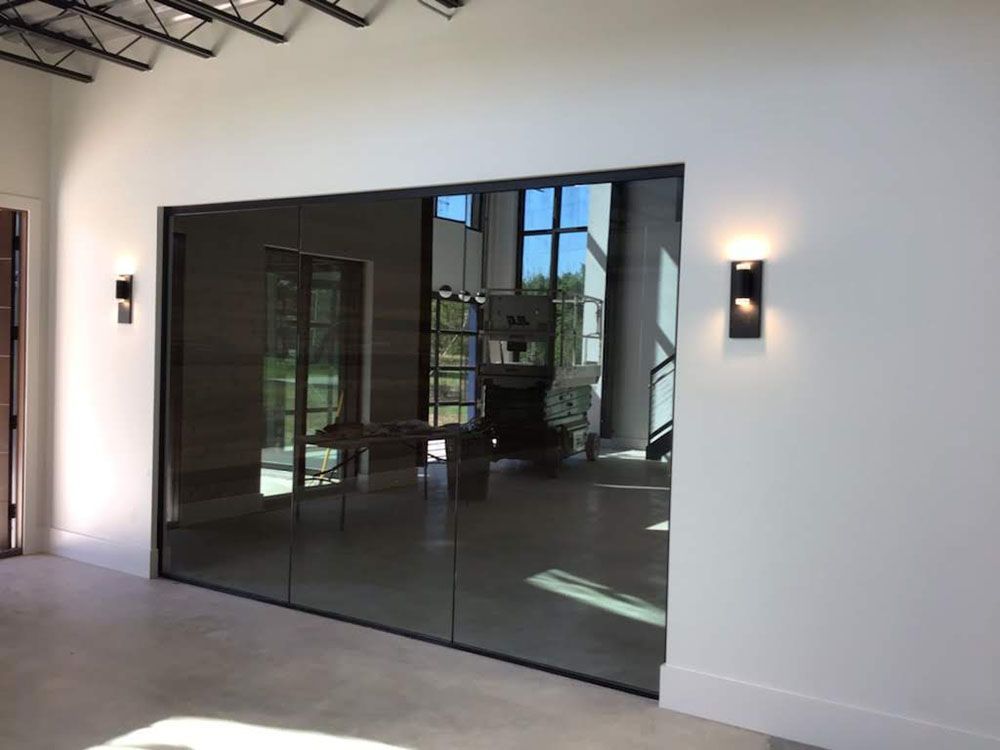 A room with a sliding glass door between two rooms