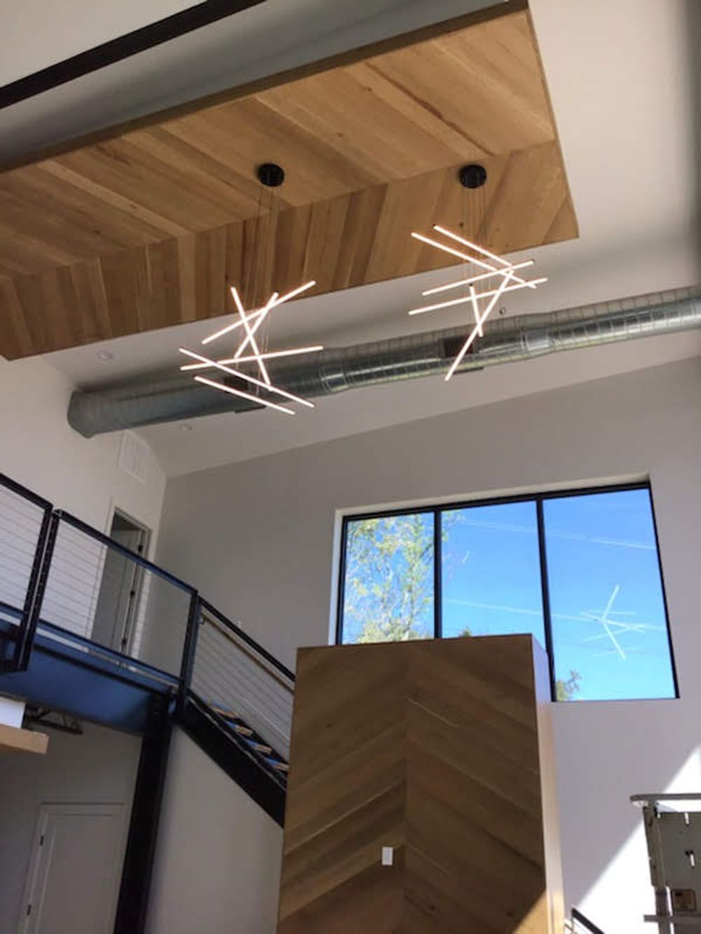 A room with a wooden ceiling and a staircase