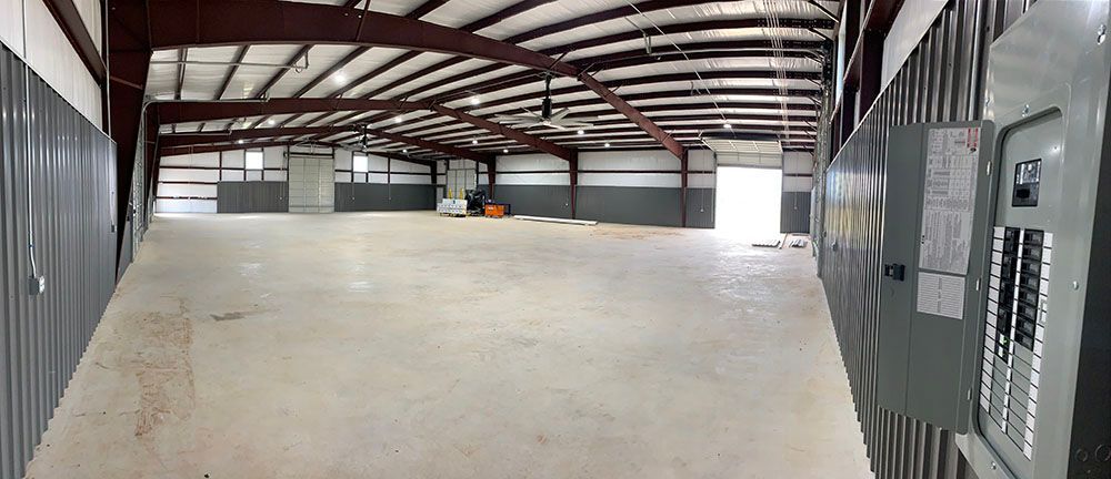 A large empty warehouse with a lot of electrical panels