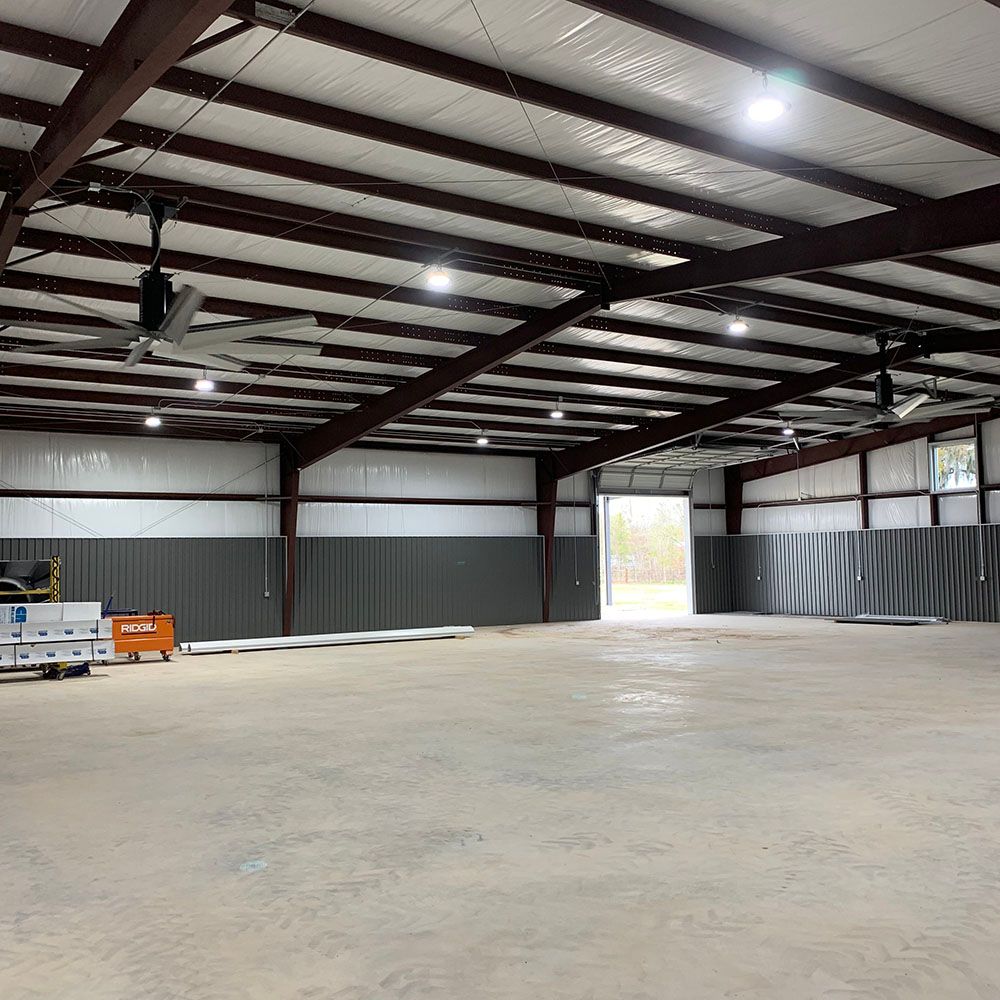 A large empty warehouse with a lot of ceiling fans