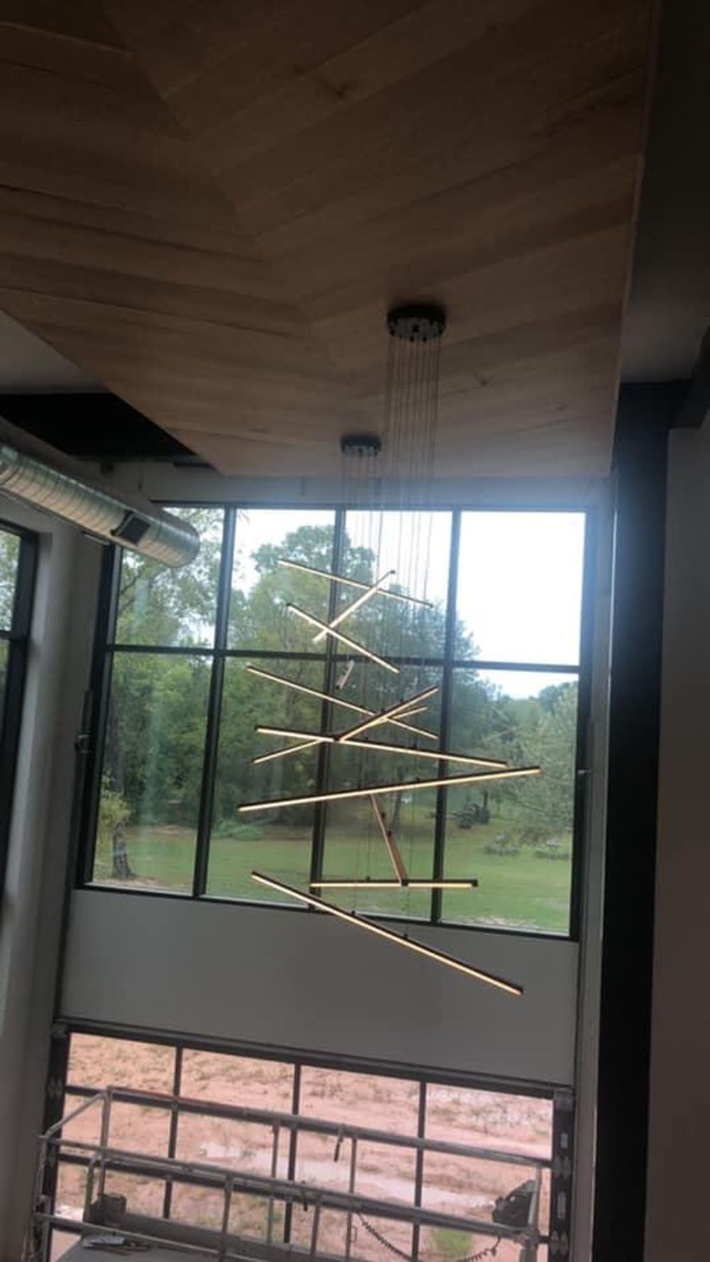 A large window with a chandelier hanging from the ceiling