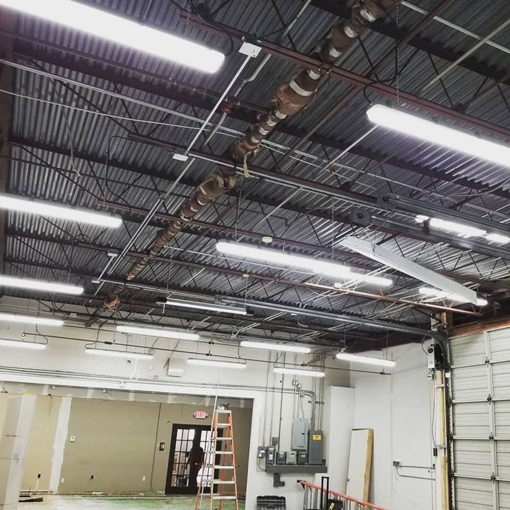 A large room with lots of lights hanging from the ceiling