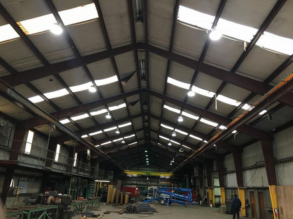 A large warehouse with a lot of windows and lights