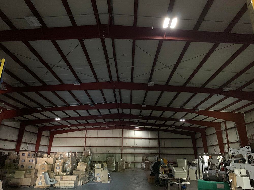 A well-lighted warehouse filled with lots of boxes and machinery