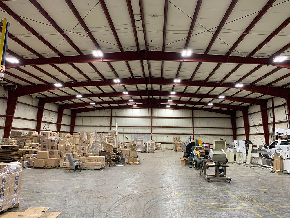 A large well-lighted warehouse filled with lots of boxes and machinery