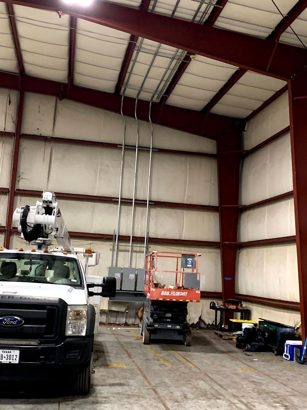 A truck is parked in a large warehouse
