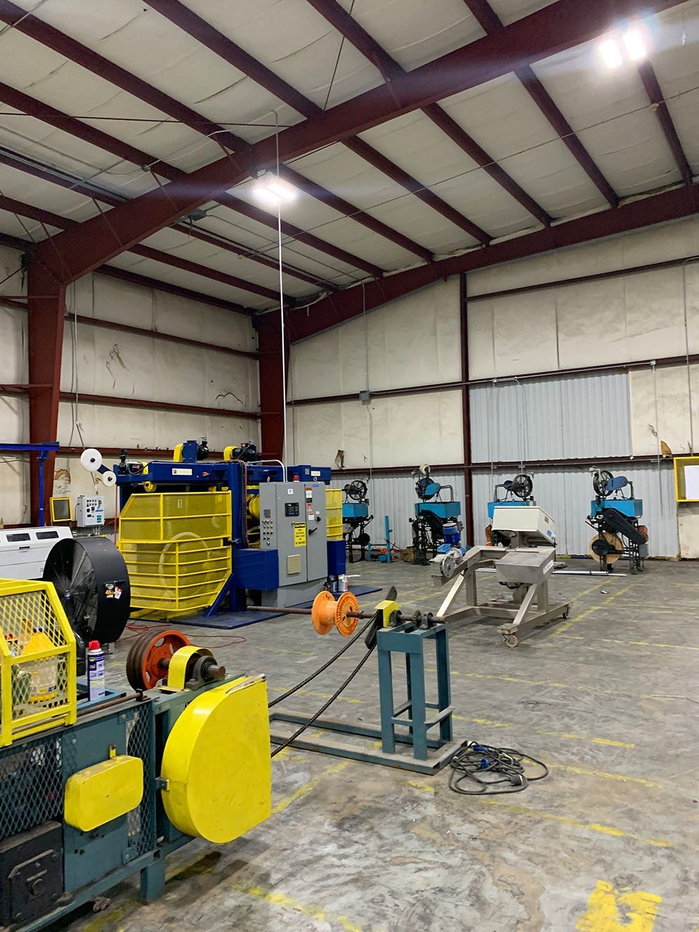 A large well-lighted warehouse with a lot of machinery in it