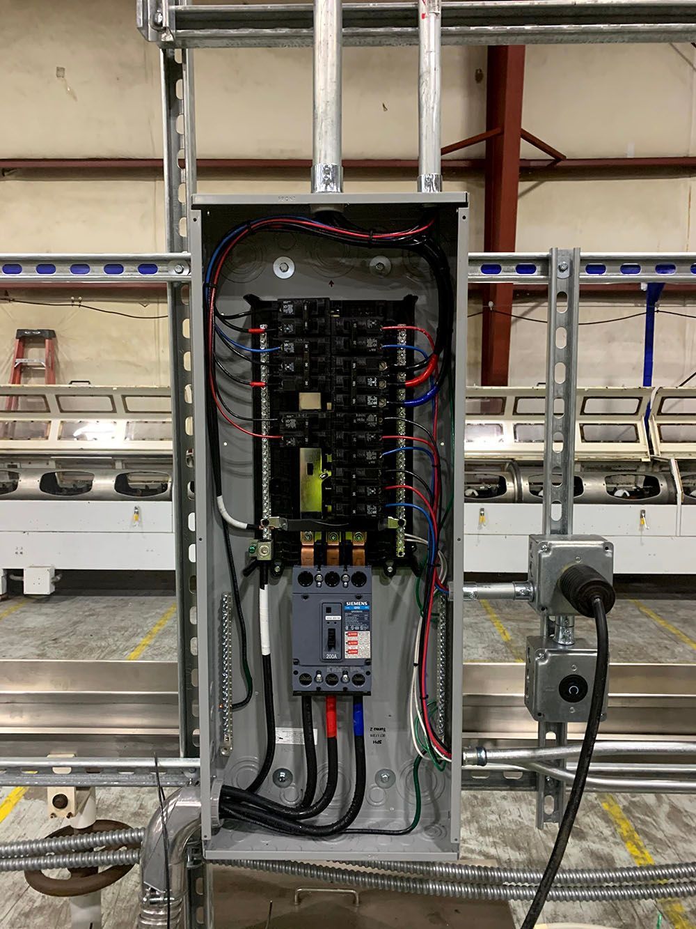 An electrical box with a lot of wires coming out of it